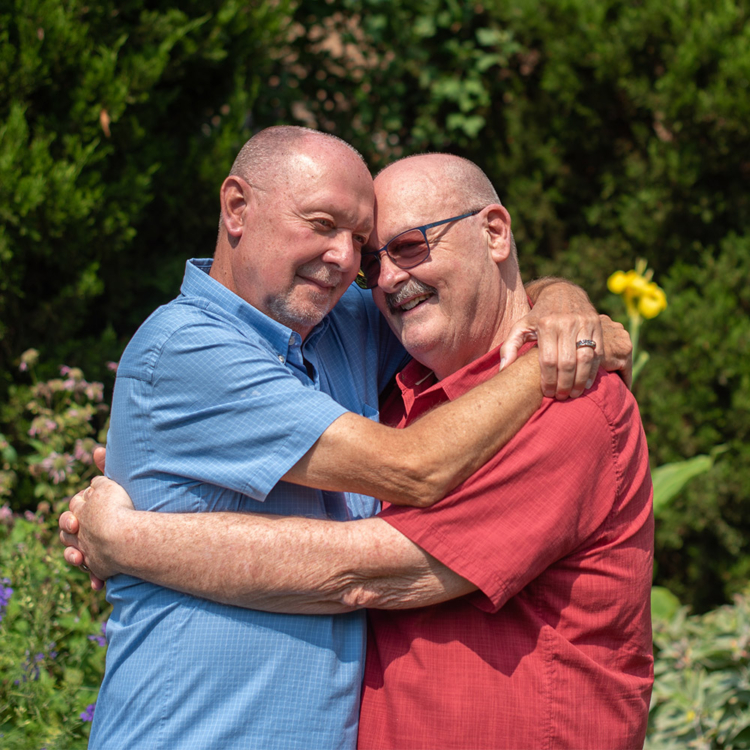 Two older men in embrace